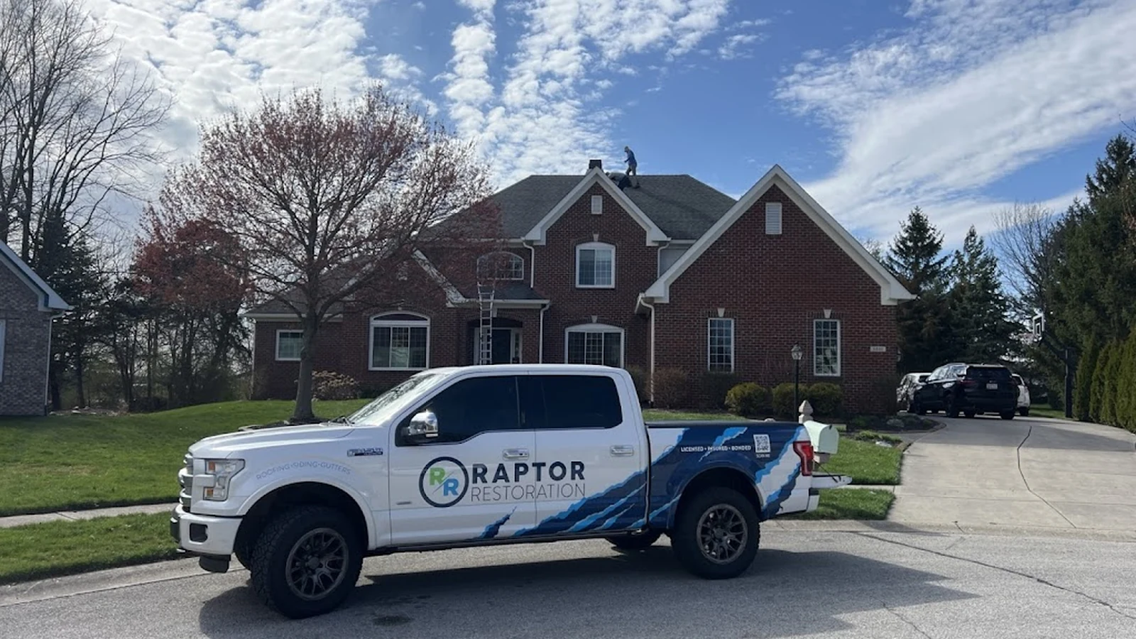 Raptor Roofing truck at a residential roof replacement project in Central Indiana