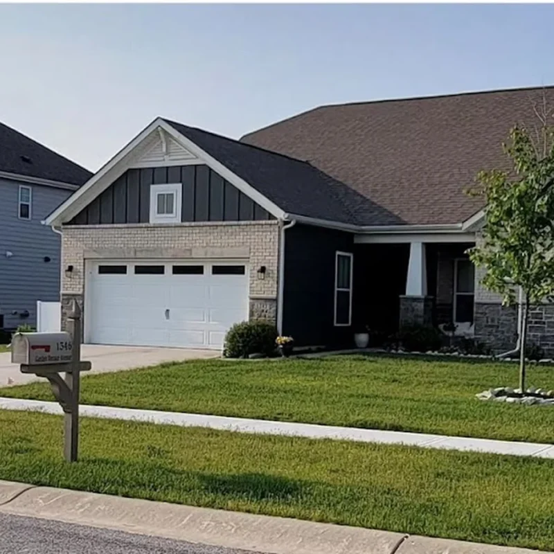 Well-maintained Indiana home with an architectural shingle roof under a clear sky, illustrating residential roof lifespan and long-term curb appeal