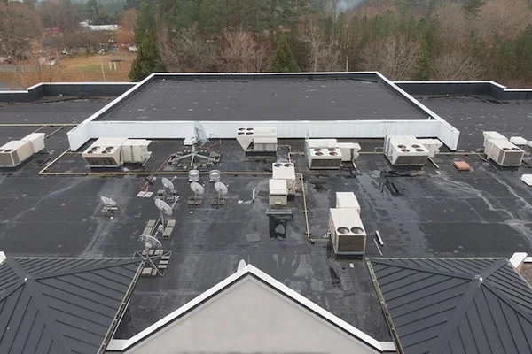 Aerial view of a commercial flat roof being evaluated for restoration