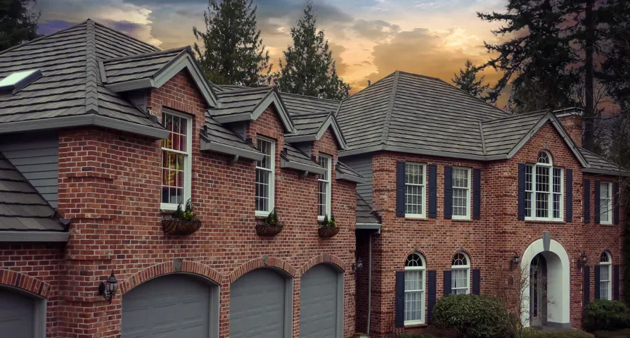 Gray stone coated steel roof on a brick home suitable for Indiana neighborhoods
