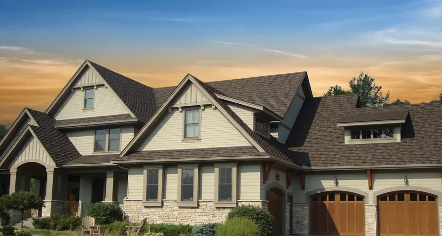 Stone coated steel shingle roof on a residential home with warm evening light
