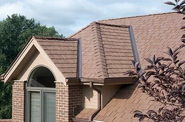 Synthetic shake roof on a brick home with steep rooflines