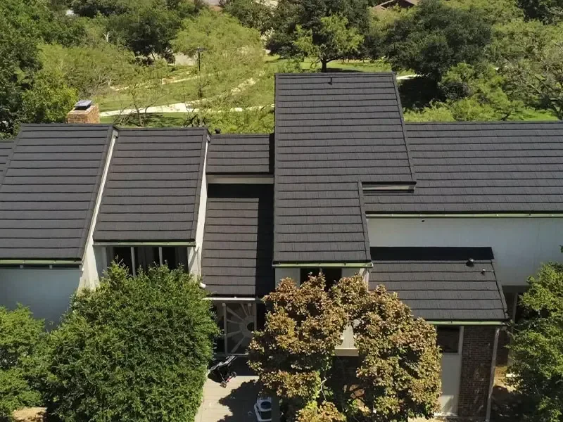 Stone-coated steel roof on a wooded home similar to Greenwood Indiana neighborhoods with mature trees