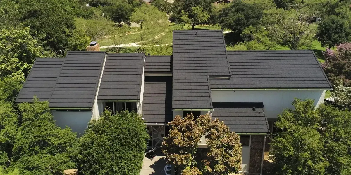 Stone-coated steel roof on a wooded home similar to Greenwood Indiana neighborhoods with mature trees