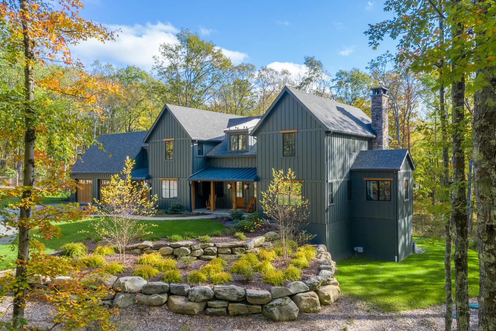 Blue James Hardie lap siding on a wooded residential home exterior