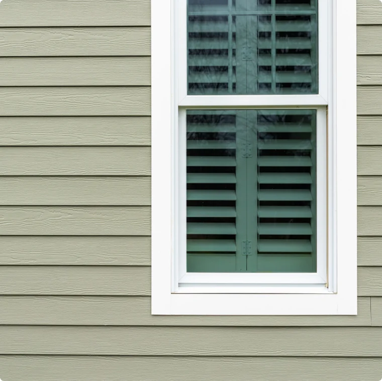 James Hardie window trim detail with gray siding and white trim