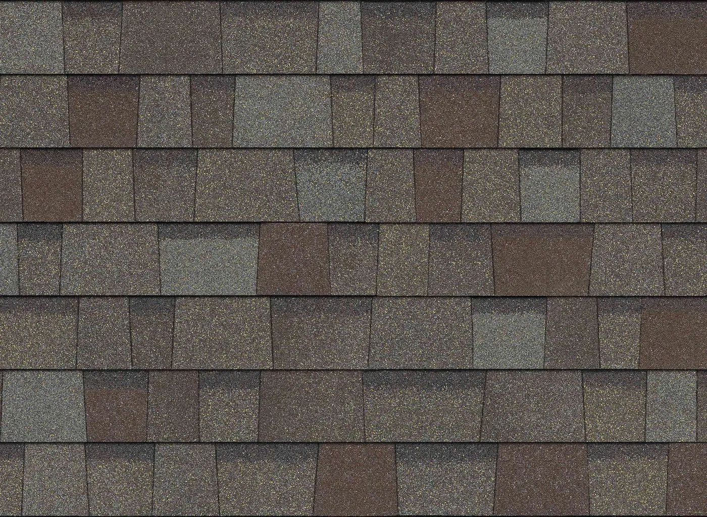 Close-up of driftwood architectural asphalt shingles showing mixed gray and warm brown granules
