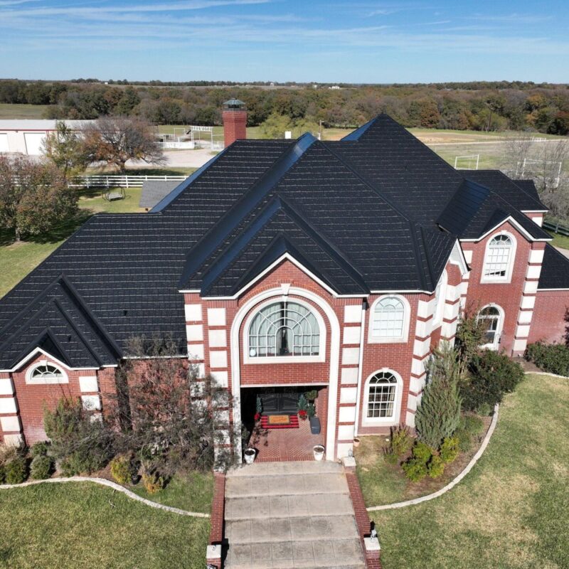 Black EDCO ArrowLine metal roof on a brick home