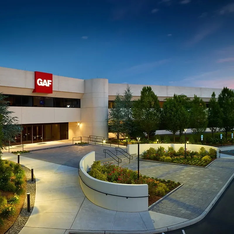 Office building entrance and landscaped grounds at dusk