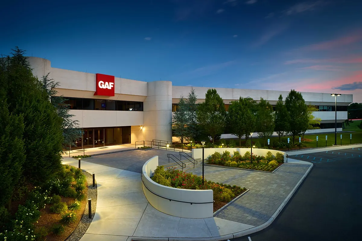 Office building entrance and landscaped grounds at dusk
