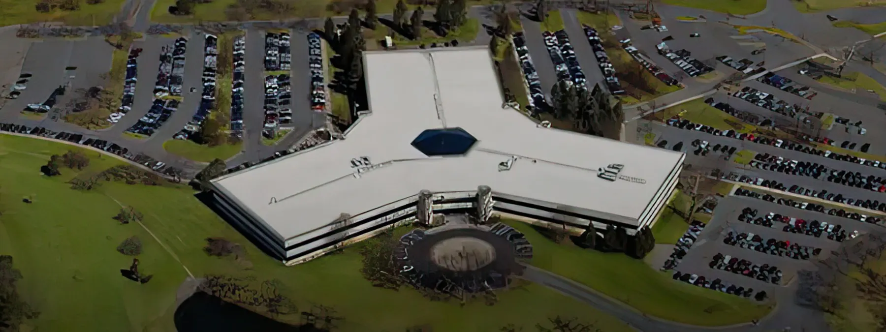 Aerial view of an office campus with a white low-slope roof
