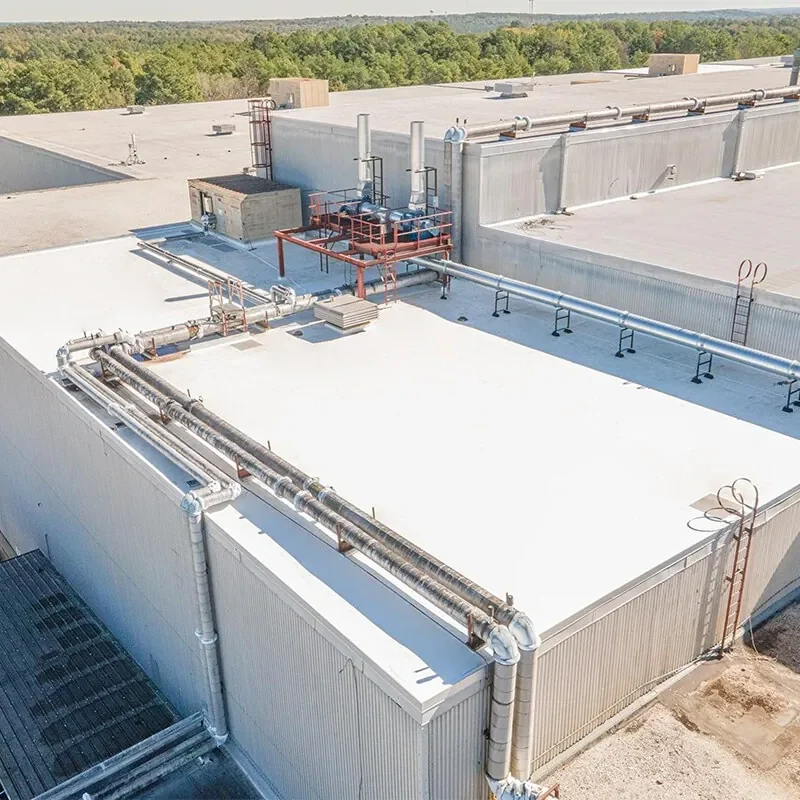 Completed white TPO roof with equipment curbs and raised roof sections