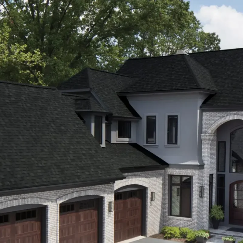 Black dimensional shingles across the gables of a light brick home