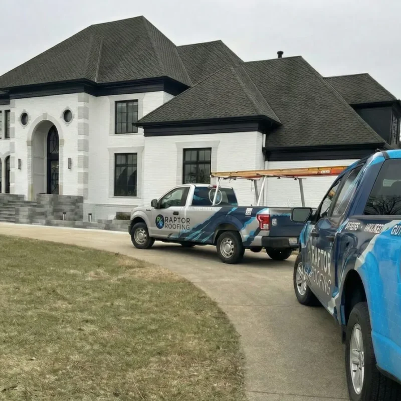 Completed Central Indiana roof replacement with Raptor Roofing trucks at the home
